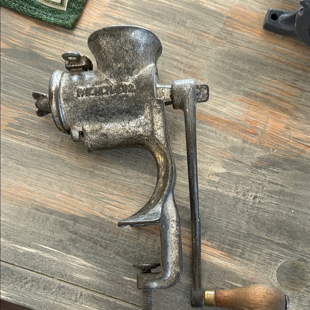 Old meat grinder says Russellerwin 
Or Russwin . Clamps to table top
